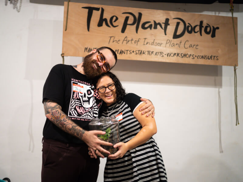 Couple smiling with their terrarium at a terrarium making class in Brisbane